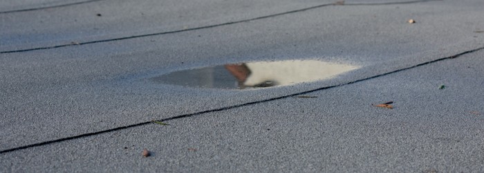 How to drain ponding water on a flat commercial roof